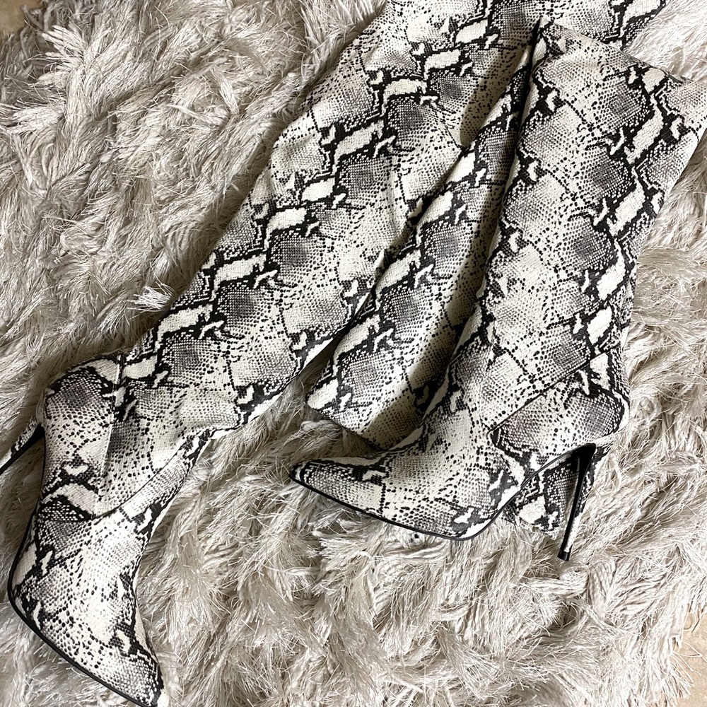 Steve Madden thigh high snake print boots.